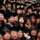 Graduates attend a graduation ceremony at Fudan University in Shanghai